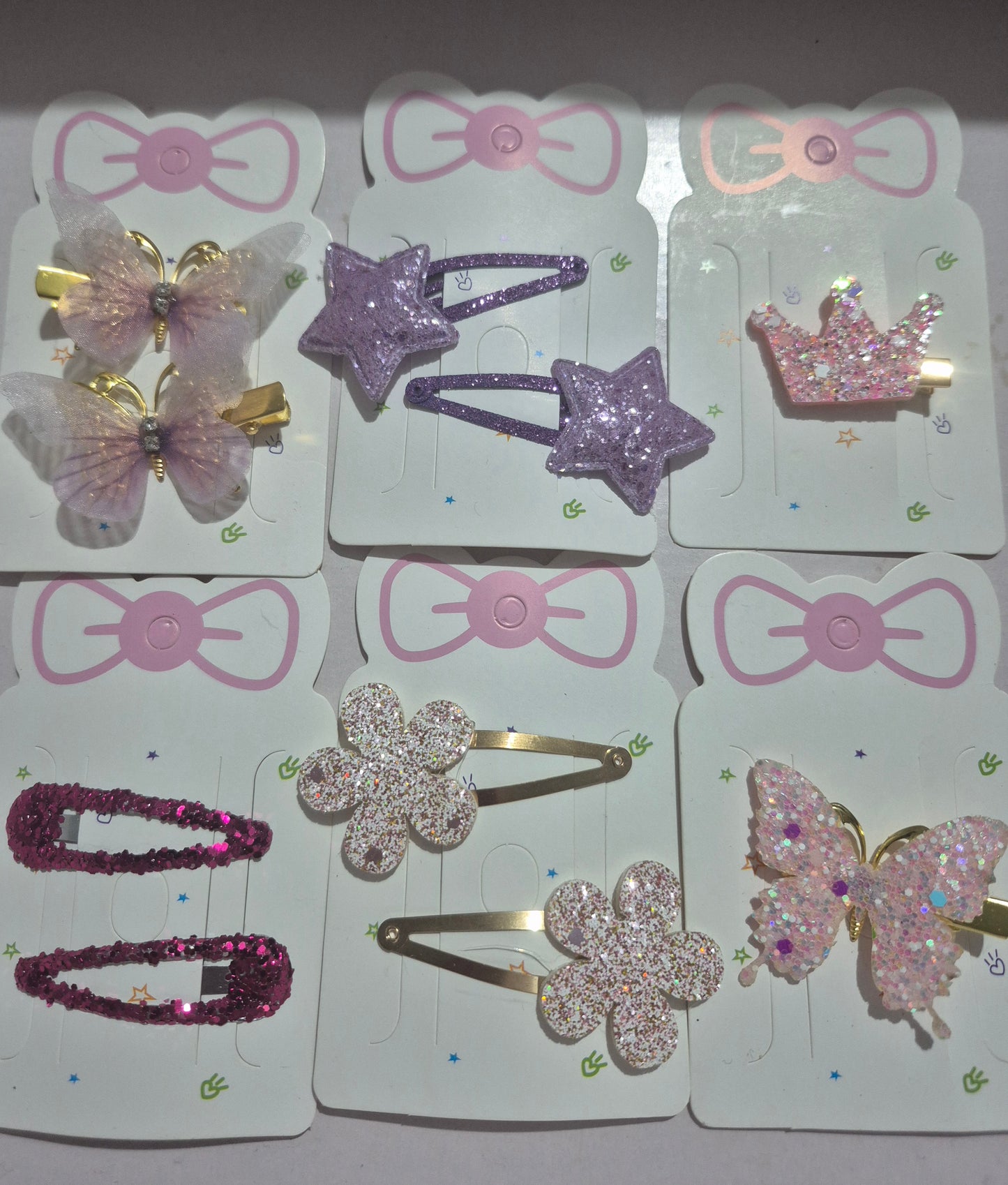 Set of colorful hair accessories on display cards with decorative bows and shapes.