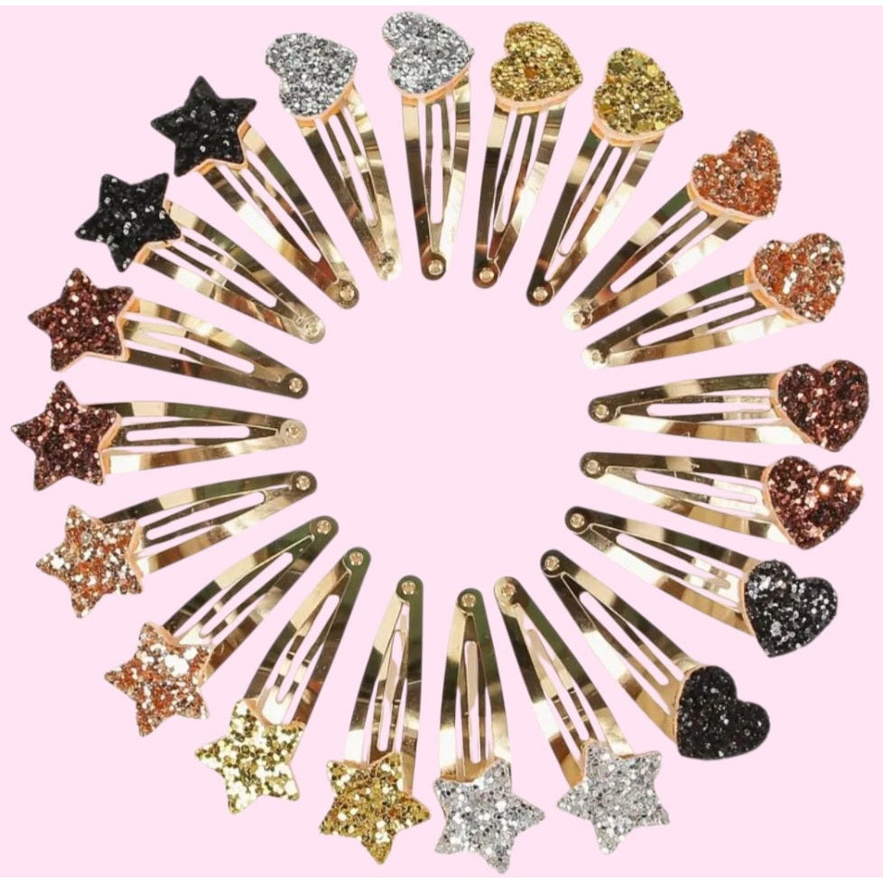 Decorative hair clips with stars and hearts on a pink background