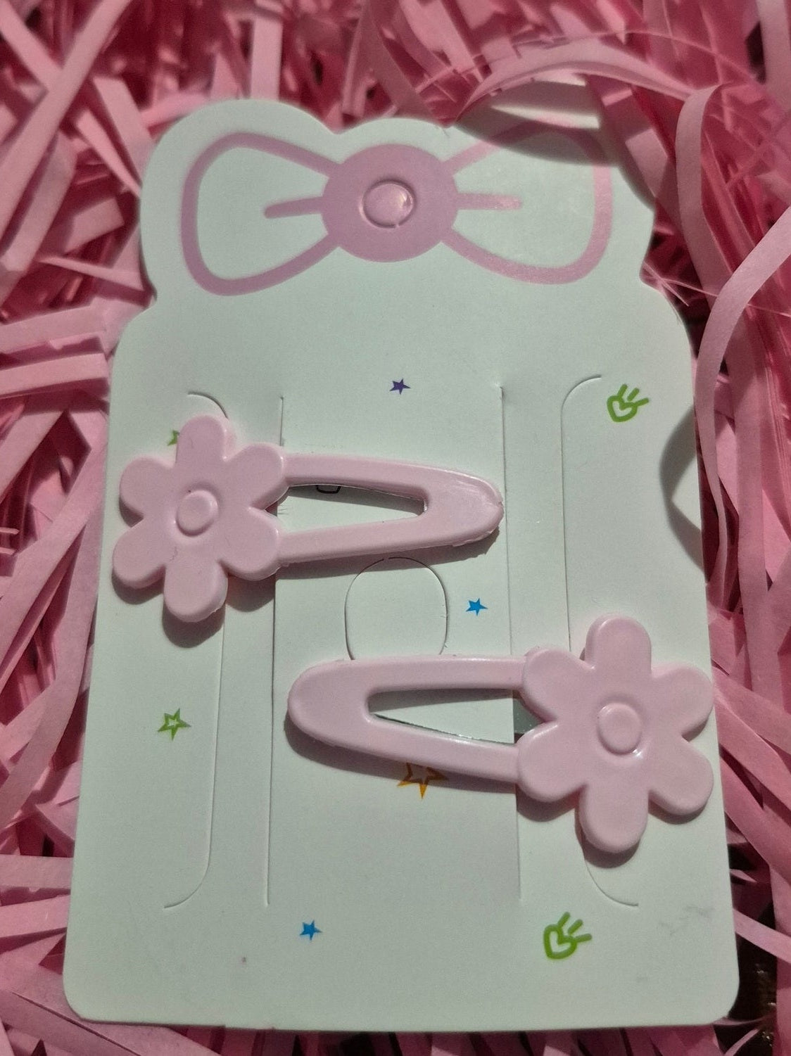 Card with floral and bow designs on pink shredded paper