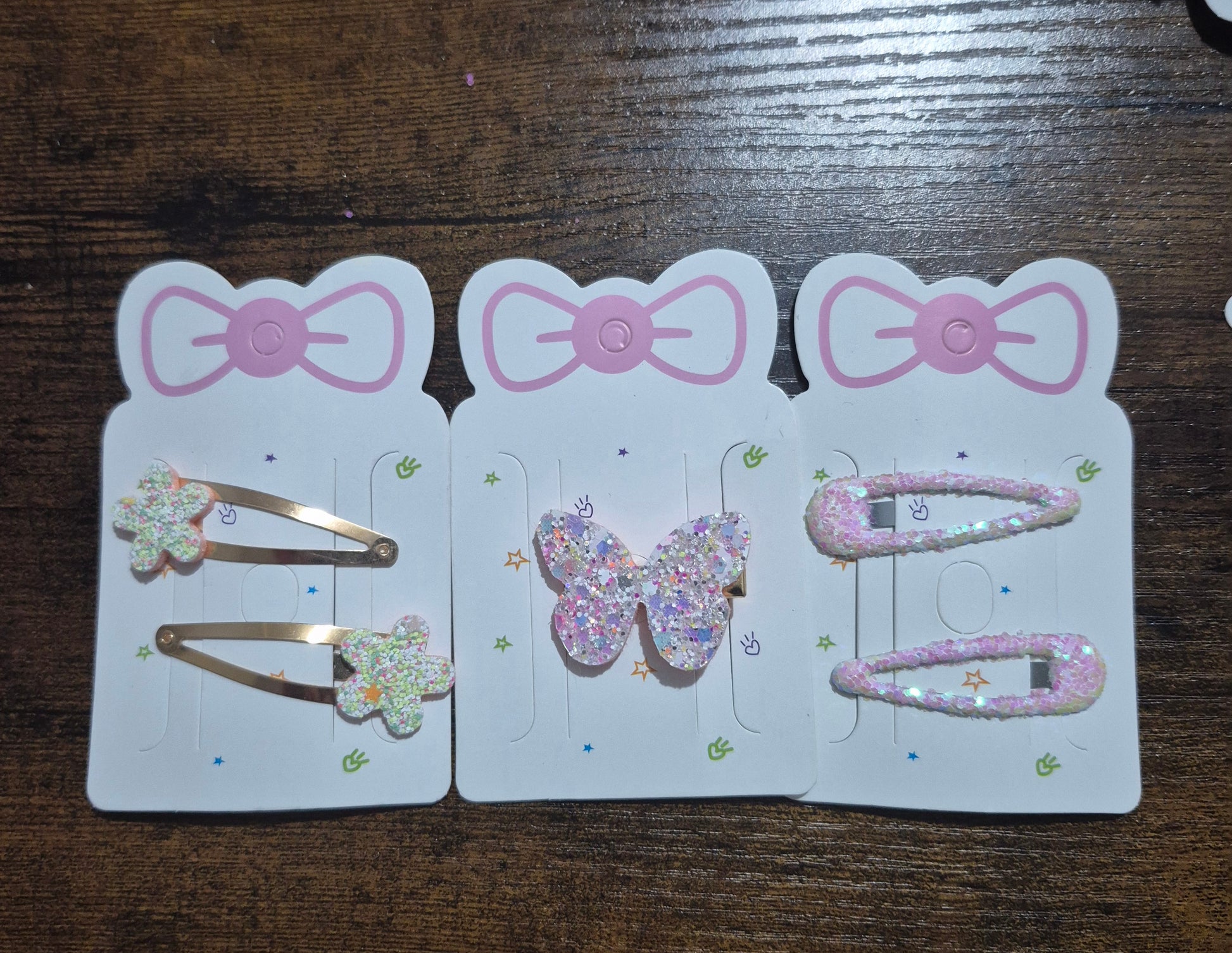 Set of hair clips with decorative elements on a wooden surface