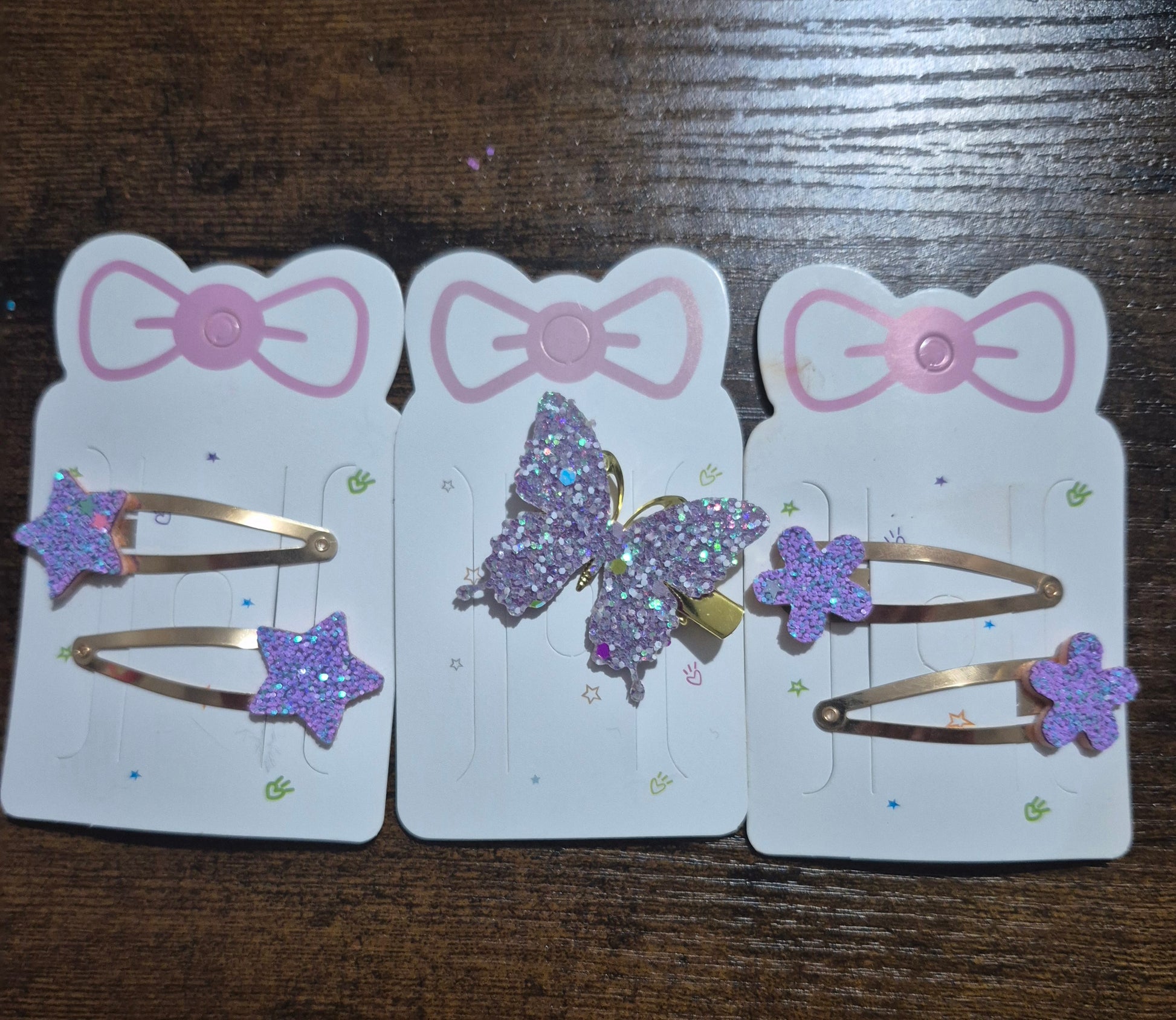 Set of hair accessories with bows and decorative elements on a wooden surface