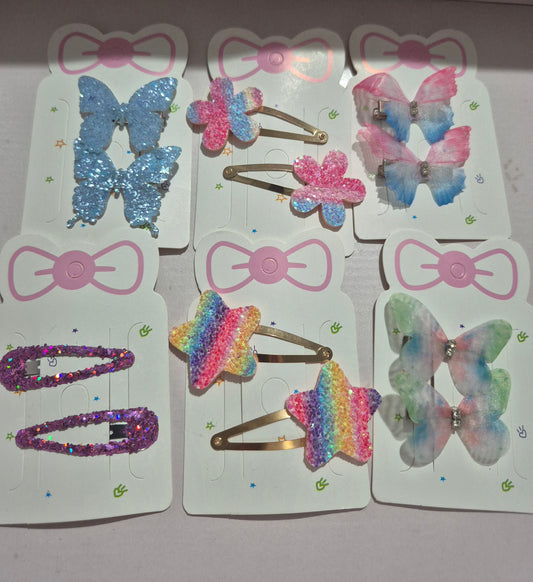 Colorful butterfly-shaped hair clips on display cards with decorative bows.