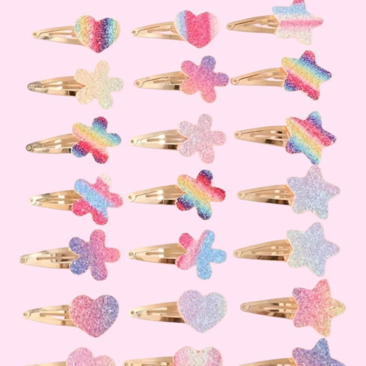 Collection of colorful hair clips with various shapes on a pink background