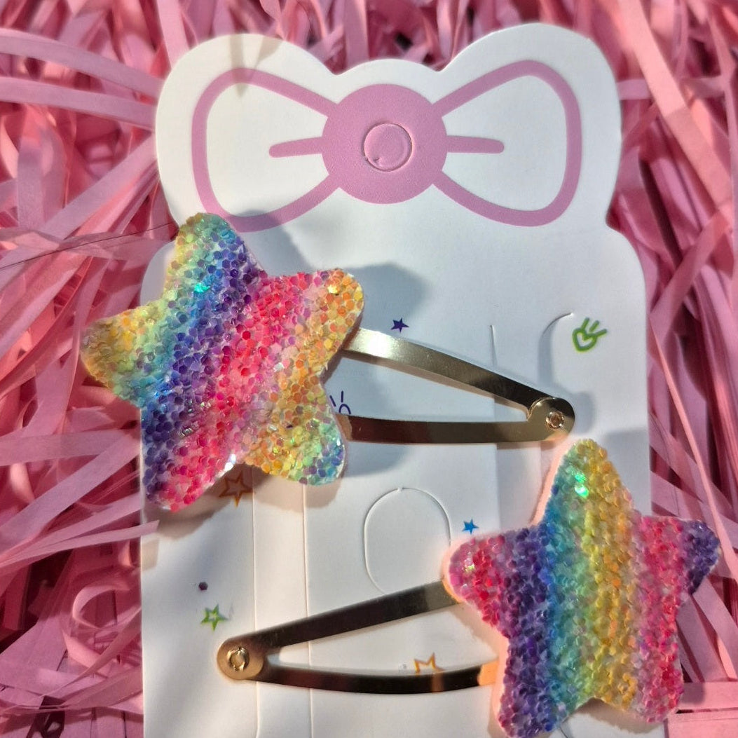 Colorful butterfly hair clips on a Hello Kitty branded card with pink shredded paper background