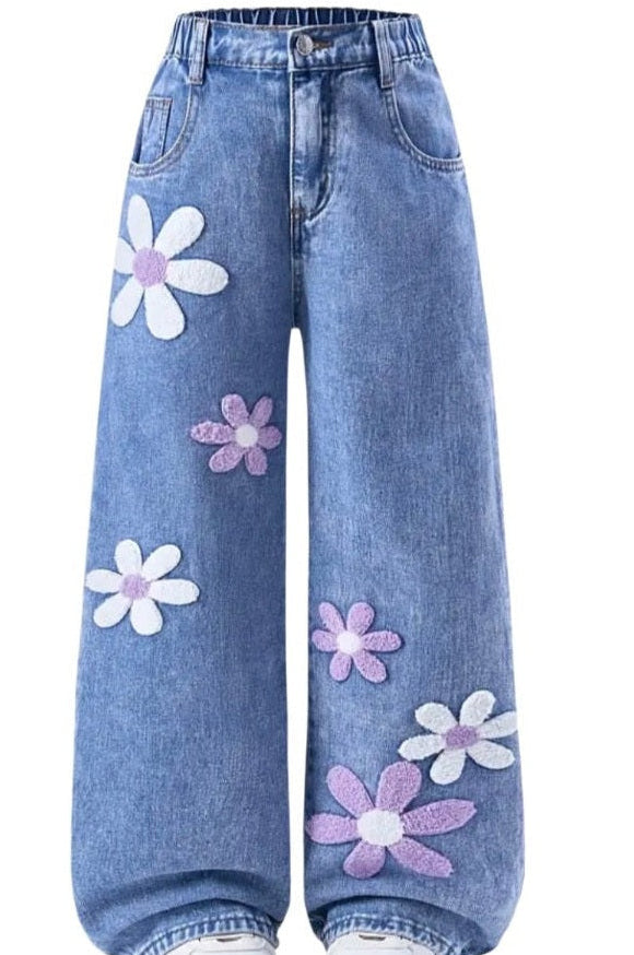 Blue jeans with floral patterns on a white background